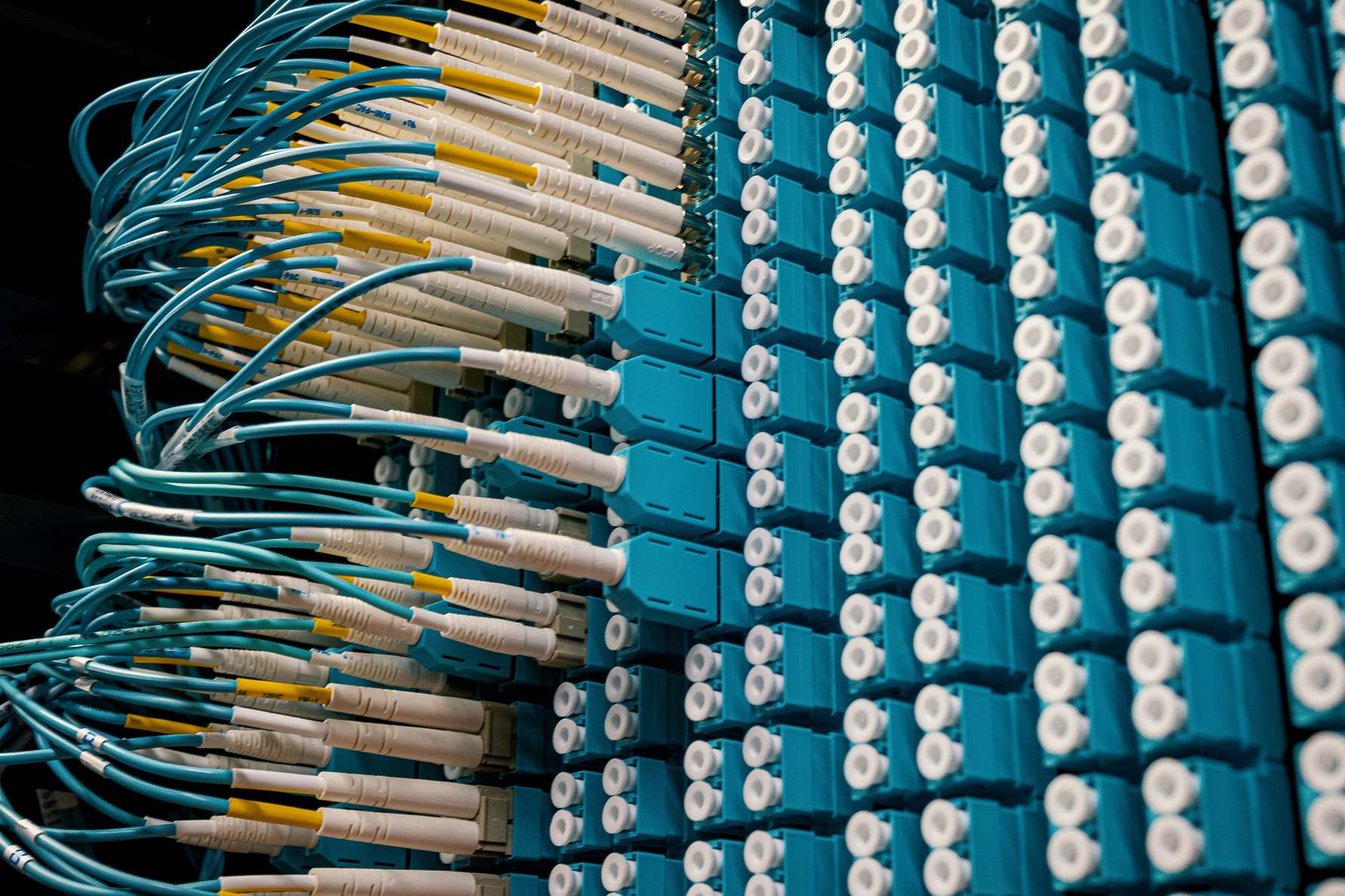 Wide view of fiber optic equipment with structured colorful cables